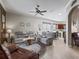 Open-concept living room featuring a glimpse of the kitchen, comfortable seating, and neutral decor at 17769 Se 121St Terrace Rd, Summerfield, FL 34491