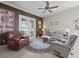Comfortable living room with reclining furniture, french doors, and outdoor views at 17769 Se 121St Terrace Rd, Summerfield, FL 34491