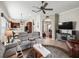 Spacious living room leading to the kitchen and entryway, featuring cozy seating and tile floors at 17769 Se 121St Terrace Rd, Summerfield, FL 34491