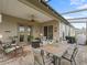 Screened patio with a paver floor, dining table, seating area, grill, and views of the backyard at 17769 Se 121St Terrace Rd, Summerfield, FL 34491