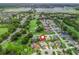 Aerial view of neighborhood and home with in ground pool located on golf course at 1804 Estafana Way, The Villages, FL 32159