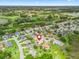 Aerial view of the neighborhood, home with pool, and golf course at 1804 Estafana Way, The Villages, FL 32159