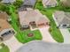 Aerial view of a single story home with a beautiful lawn, garden, and two car garage at 1804 Estafana Way, The Villages, FL 32159