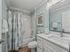 Bathroom featuring modern sink, toilet, tub and a floral shower curtain, complete with stylish lighting and finishes at 1804 Estafana Way, The Villages, FL 32159