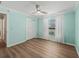 A bedroom featuring wood floors, a ceiling fan, a window, and a closet, bathed in sunlight at 1804 Estafana Way, The Villages, FL 32159