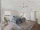 Bedroom boasts wood floors, a ceiling fan, and a beautiful rug, offering a cozy and stylish retreat at 1804 Estafana Way, The Villages, FL 32159