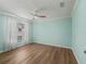 An empty bedroom features stylish wood floors and a ceiling fan, ready to be personalized at 1804 Estafana Way, The Villages, FL 32159