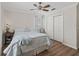 Bedroom featuring a comfortable bed, wood floors, a window, and ample closet space at 1804 Estafana Way, The Villages, FL 32159