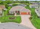 Charming single-story home with a three-car garage, manicured lawn, and colorful landscaping at 1804 Estafana Way, The Villages, FL 32159