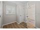 Hallway area featuring wood floors, neutral paint, and natural light from a window at 1804 Estafana Way, The Villages, FL 32159