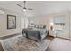 Serene main bedroom with a patterned rug, ceiling fan, and natural light from the large windows at 1804 Estafana Way, The Villages, FL 32159