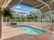 Backyard in ground pool with screened in enclosure and partial sun shade at 1804 Estafana Way, The Villages, FL 32159