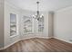 Cozy dining area features wood flooring and a charming chandelier at 1804 Estafana Way, The Villages, FL 32159