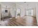 Inviting foyer with wood floors, a chandelier, and views to the kitchen and dining area at 1804 Estafana Way, The Villages, FL 32159