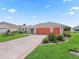 Beautiful single-story home featuring a well-manicured lawn and 3-car garage at 1804 Estafana Way, The Villages, FL 32159