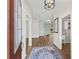 Bright foyer features wood flooring, an elegant light fixture, and seamless access to other rooms at 1804 Estafana Way, The Villages, FL 32159