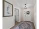 Bright foyer features wood flooring and a stylish area rug at 1804 Estafana Way, The Villages, FL 32159