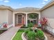 Inviting front porch with well-maintained landscaping, seating, and tasteful decor at 1804 Estafana Way, The Villages, FL 32159