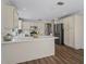Bright kitchen boasts stainless steel appliances, spacious counter tops and wood-look flooring at 1804 Estafana Way, The Villages, FL 32159