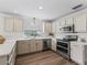 Bright kitchen featuring white cabinetry, quartz countertops, and stainless steel appliances at 1804 Estafana Way, The Villages, FL 32159