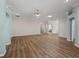 Spacious living room featuring wood floors, modern ceiling fan, and an open layout at 1804 Estafana Way, The Villages, FL 32159
