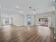 Open-concept living area with wood floors, neutral walls and natural light at 1804 Estafana Way, The Villages, FL 32159