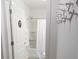 A well-lit bathroom featuring a shower, decorative coat rack, and stylish fixtures, providing a functional and aesthetically pleasing space at 1914 Hux Ct, The Villages, FL 34762