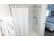 Bright bathroom featuring a shower with a white curtain, adding a touch of elegance and privacy to the space at 1914 Hux Ct, The Villages, FL 34762