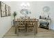 Stylish dining room with contemporary decor, a wooden table set, and modern lighting fixtures at 1914 Hux Ct, The Villages, FL 34762