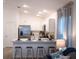 Modern kitchen with white cabinetry, stainless steel appliances, and a breakfast bar for casual dining at 1914 Hux Ct, The Villages, FL 34762