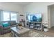 Cozy living area with comfortable seating, a media center, and tasteful décor, perfect for relaxation at 1914 Hux Ct, The Villages, FL 34762