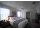 Serene main bedroom featuring a plush bed, soft lighting, and ample closet space at 1914 Hux Ct, The Villages, FL 34762