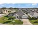 Aerial view of home highlighting front yard landscaping and pool at 1940 Dempsey Ln, The Villages, FL 32163