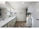 Bathroom with double sinks, ample counter space and wood-look flooring at 1940 Dempsey Ln, The Villages, FL 32163