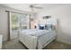 Cozy bedroom with a full bed, ceiling fan, and bright natural light at 1940 Dempsey Ln, The Villages, FL 32163