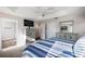 Spacious bedroom with tray ceiling, ceiling fan, and neutral-toned furniture at 1940 Dempsey Ln, The Villages, FL 32163