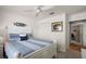 Bright bedroom with blue and white striped bedding, ceiling fan, and closet at 1940 Dempsey Ln, The Villages, FL 32163