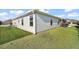 Rear exterior of house featuring low-maintenance vinyl siding and manicured lawn at 1940 Dempsey Ln, The Villages, FL 32163