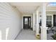 Charming front porch with decorative pillars and a cozy ambiance at 1940 Dempsey Ln, The Villages, FL 32163
