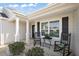 Welcoming front porch with rocking chairs and decorative details at 1940 Dempsey Ln, The Villages, FL 32163