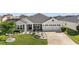 Well-maintained home with charming landscaping, manicured lawn, and welcoming curb appeal at 1940 Dempsey Ln, The Villages, FL 32163