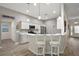 Bright kitchen boasts stainless steel appliances, bar seating and light wood floors at 1940 Dempsey Ln, The Villages, FL 32163