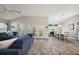 Open-concept living room with hardwood floors and access to the dining area at 1940 Dempsey Ln, The Villages, FL 32163