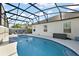 Inviting screened-in pool area with comfortable seating, perfect for relaxation and entertaining at 1940 Dempsey Ln, The Villages, FL 32163