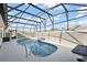 Private pool with decorative water feature, set in screened enclosure at 1940 Dempsey Ln, The Villages, FL 32163