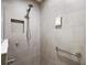 Modern bathroom shower with gray tiles and grab bar at 1940 Dempsey Ln, The Villages, FL 32163