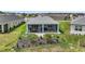 Aerial view of home with screened-in lanai and landscaping at 1966 Wallingford Loop, Mount Dora, FL 32757