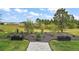 Landscaped backyard with neatly manicured lawn and flowerbeds, providing a serene outdoor space at 1966 Wallingford Loop, Mount Dora, FL 32757