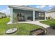 Backyard showing screened-in patio and stone landscaping at 1966 Wallingford Loop, Mount Dora, FL 32757