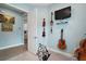 Spare bedroom showcasing guitars and art on the walls. The door opens to the kitchen at 1966 Wallingford Loop, Mount Dora, FL 32757